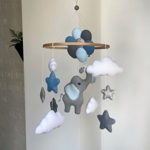 Elephant mobile baby boy nursery. Balloons stars and clouds crib decor