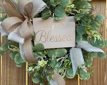 Simply blessed door wreath with Eucalyptus, greenery and berries on woven grapevine base. Simply blessed faux embroidery on stretched canvas