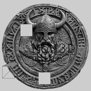 May include: A silver circular shield featuring a Viking warrior wearing a horned helmet and a beard. The shield is decorated with intricate carvings and runes. The text "MON3D" is visible in the centre of the shield.