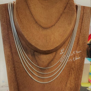 May include: Four silver snake chains of different widths displayed on a wooden mannequin. The chains are labeled with their widths in millimeters: 1.0 mm, 1.2 mm, 1.4 mm, and 1.6 mm.