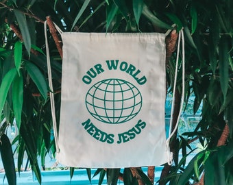 Our World Needs Jesus Drawstring Backpack | Drawstring Tote Bag With Pocket | Christian Tote Bag | Christian | Christian Drawstring Bag