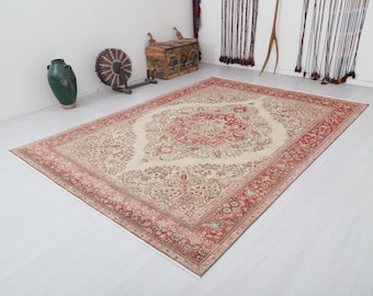 May include: A vintage cream-colored rug with a red and cream floral pattern. The rug has a detailed border with a repeating floral design.