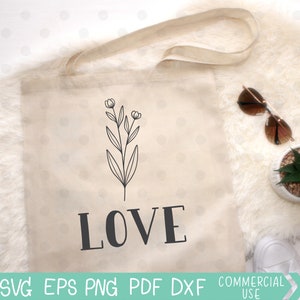 May include: A white tote bag with a black floral design and the word "LOVE" printed in black letters.