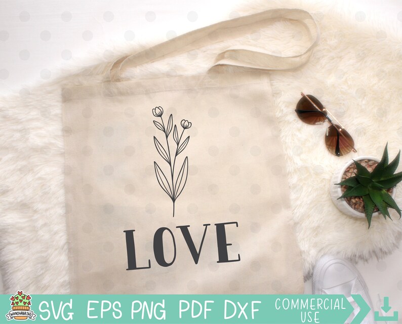 May include: A white tote bag with a black floral design and the word "LOVE" printed in black letters.