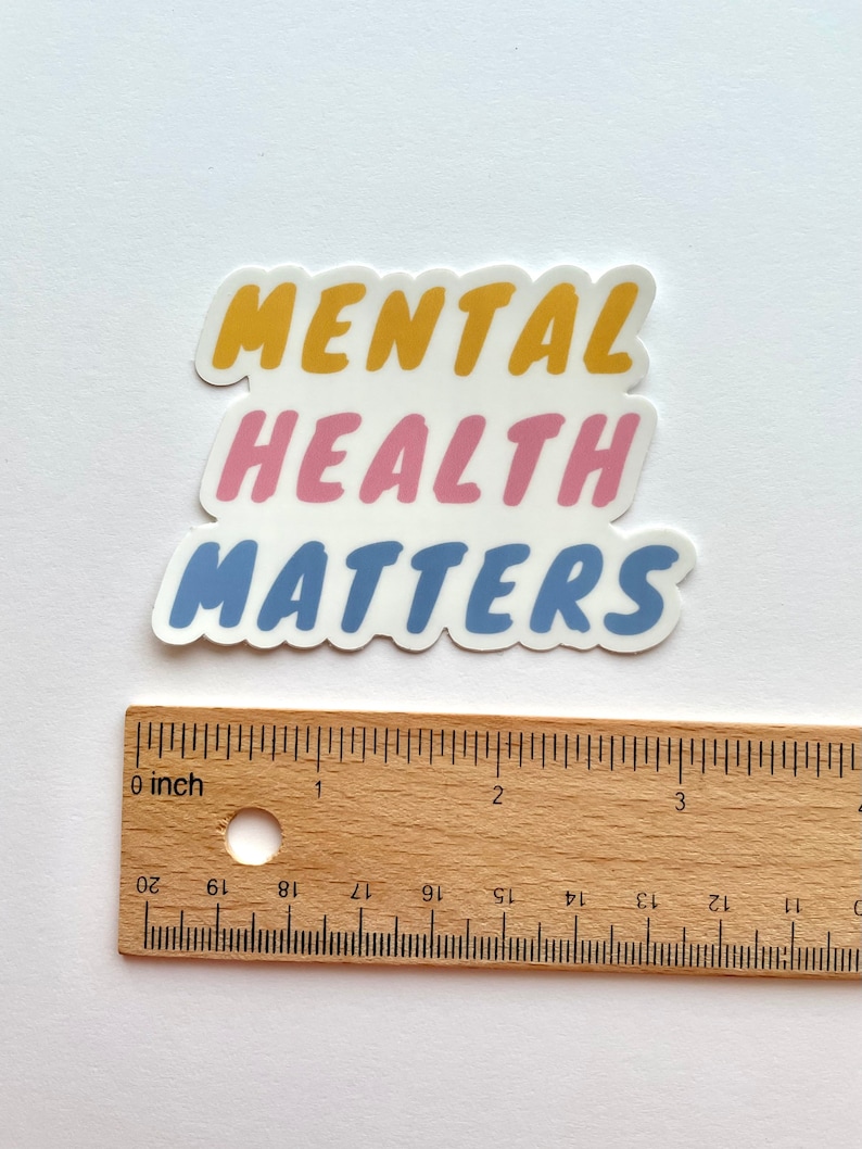 May include: A sticker with the words "Mental Health Matters" in a layered design. The words "Mental" are in yellow, "Health" are in pink, and "Matters" are in blue.