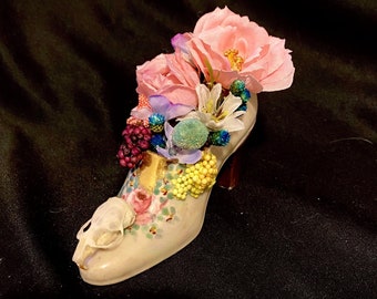Antique, shoe miniature, mouse skull, faux flowers.
