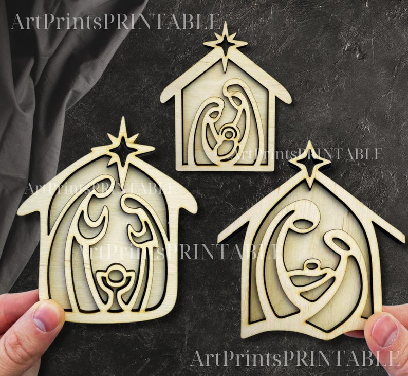 May include: Three wooden nativity scene ornaments. Each ornament features a house shape with a star on top and a cutout design depicting Mary, Joseph, and baby Jesus. The ornaments are made of light-colored wood.
