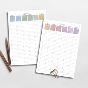 May include: Two undated 2026 planner pages with monthly calendars in pastel colors. The pages are white with a grid of lines for daily entries. Two pencils and a gold paper clip are also visible.