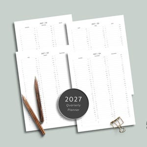 May include: A 2027 quarterly planner set consisting of four white paper sheets with monthly calendars, two wooden pencils, and a silver metal binder clip. A circular black label in the center displays the text 2027 Quarterly Planner.