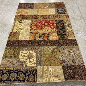 May include: A patchwork rug with a variety of colors and patterns, including red, blue, green, and gold. The rug is made up of different pieces of fabric that have been sewn together to create a unique design.