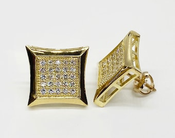 May include: A pair of gold-colored square stud earrings. Each earring features a square face with a grid of small, clear stones. The earrings have a post and backing for secure wear. The design is geometric and modern.