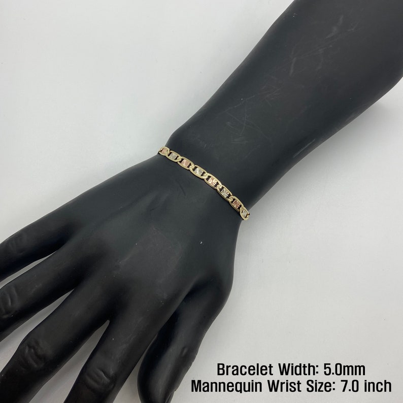 The 10k 14k Solid Gold Tri-Colored Slim Valentino Link Bracelet Anklet for Women/Girls is a gorgeous accessory available in various sizes with a 5.0mm width in a mannequin wrist size 7.0in. It’s ideal for enhancing any outfit with a touch of elegance