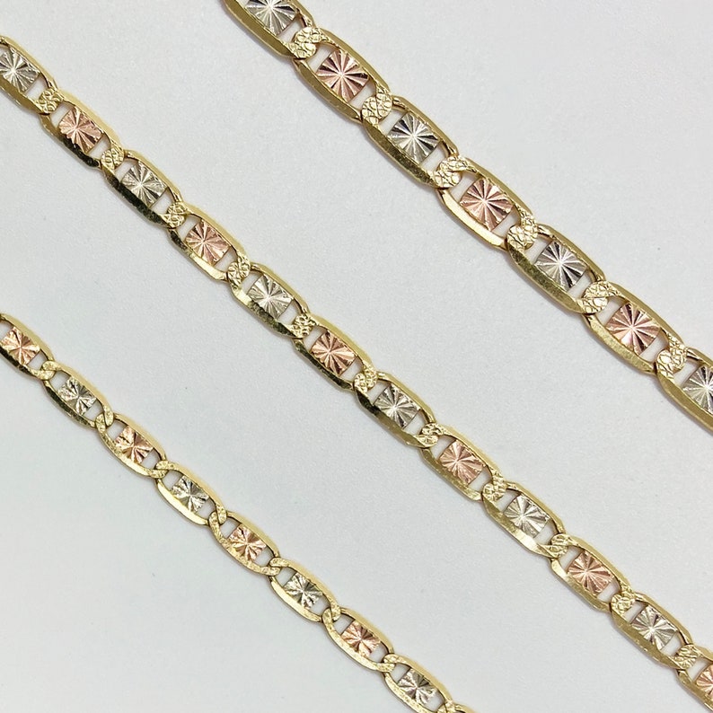 This 10k 14k Solid Gold Tri-Colored Slim Valentino Link Bracelet Anklet is perfect for women and girls. The complex design features a mix of gold, white gold, and rose gold. It's a stylish addition to any outfit, whether dressed up or down!