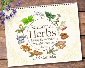 May include: A 2027 wall calendar titled Seasonal Herbs: Living Seasonally With Medicinal Plants. The cover features a central circle surrounded by watercolor illustrations of various herbs, roots, and berries, with a cream background.