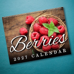 May include: A 2027 wall calendar featuring a photograph of a woven basket filled with fresh red raspberries and a green mint leaf. The word Berries is printed in a large white script font, with 2027 CALENDAR printed in white below it.