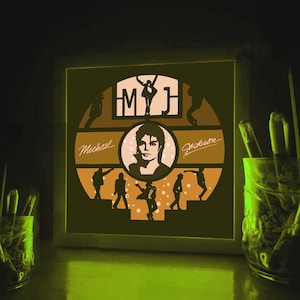 K&ouml;nnte beinhalten: Ein gerahmtes, beleuchtetes Kunstwerk mit einer Silhouette von Michael Jackson mit dem Text "MJ" und "Michael Jackson" in einem kreisf&ouml;rmigen Design.