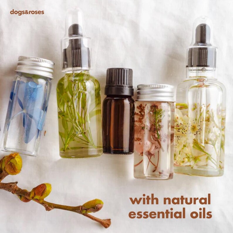 May include: Five glass bottles with clear liquid and natural ingredients inside. The bottles are labeled with the text "with natural essential oils".