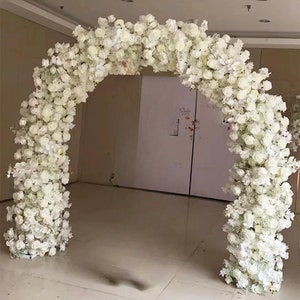 May include: A white floral archway made of artificial flowers, ideal for a wedding ceremony or special event.