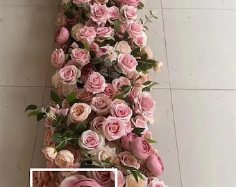 May include: A long garland of pink and white artificial roses and greenery. The garland is perfect for a wedding or other special event.