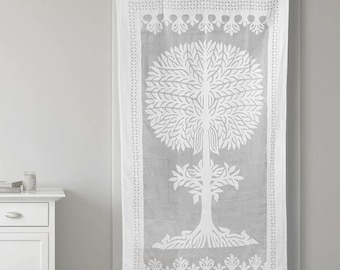 May include: White curtain with a large tree design. The tree is centered on the curtain and has a detailed leaf pattern. The curtain has a decorative border with floral and geometric patterns. The curtain is hanging from a black rod.