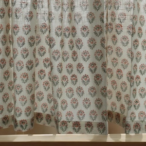 May include: White sheer curtains with a repeating pattern of small pink and green floral designs.