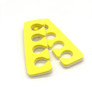 May include: Yellow foam toe separators for nail art. The separators have five holes for each toe.