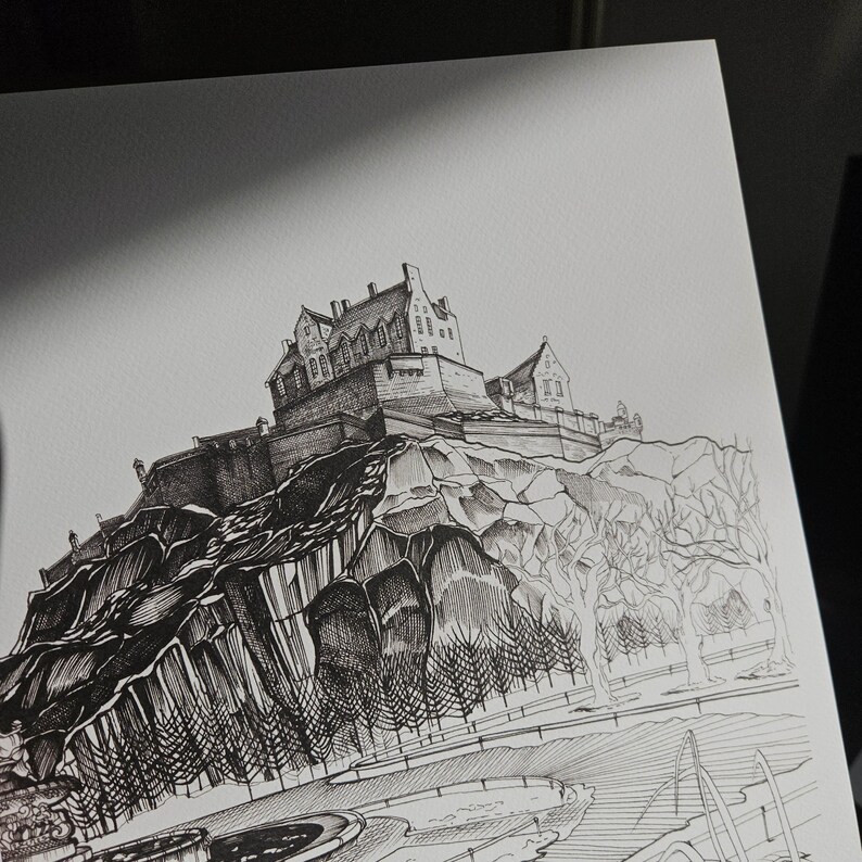 K&ouml;nnte beinhalten: Detaillierte Tuschezeichnung eines Schlosses auf einem felsigen H&uuml;gel. Das Kunstwerk zeigt filigrane Linien, die die Architektur des Schlosses, die umliegenden B&auml;ume und einen Weg darstellen. Das Bild ist in Schwarzwei&szlig; gehalten.