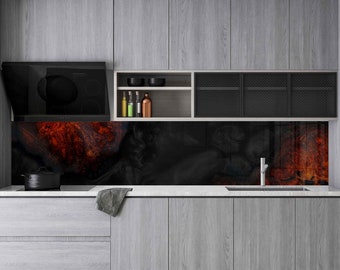 May include: A modern kitchen with gray cabinets, a black range hood, and a black and orange glass backsplash. The kitchen features a stainless steel sink and faucet.