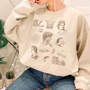 ダークアカデミアの服 オルタナティブな服 インディーズの服 ライトアカデミアの美学的な服 クルーネックのスウェットシャツ トレンディなスウェットシャツ 本のスウェットシャツ