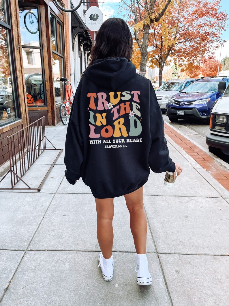 May include: Black hooded sweatshirt with a colorful graphic that says "Trust in the Lord with all your heart, Proverbs 3:5".
