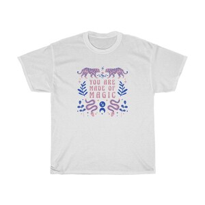 May include: White t-shirt with a pink and blue design featuring tigers, snakes, and the text "You are made of magic".
