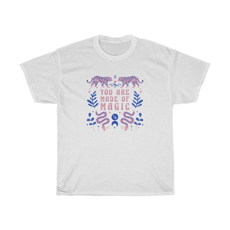 May include: White t-shirt with a pink and blue design featuring tigers, snakes, and the text "You are made of magic".
