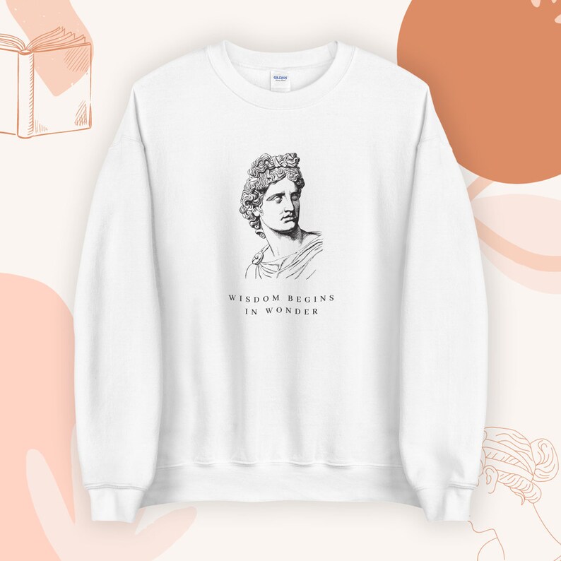 May include: White sweatshirt with a black and white illustration of a bust of a man with the text "Wisdom begins in wonder" printed below.