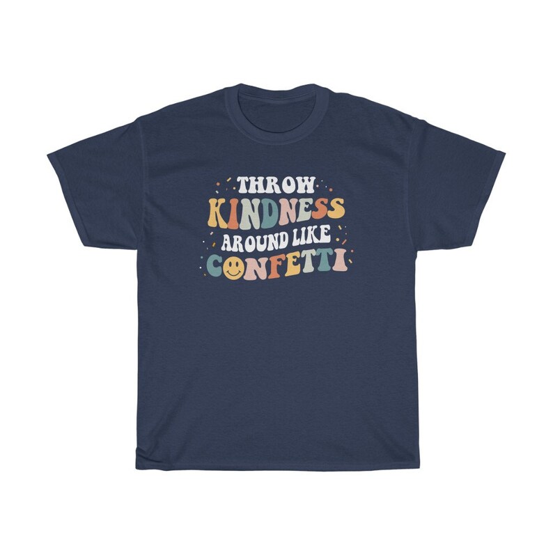 May include: Navy blue t-shirt with a retro-style graphic that says "Throw Kindness Around Like Confetti" in colourful letters with a smiley face.