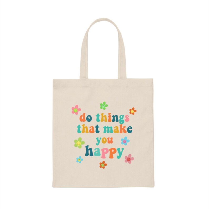 May include: A beige tote bag with a colorful graphic that says "do things that make you happy" surrounded by small flower and smiley face designs.