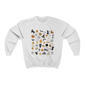 May include: White sweatshirt with a black and orange Halloween-themed print. The print features various icons such as pumpkins, ghosts, bats, witches, skulls, and more.