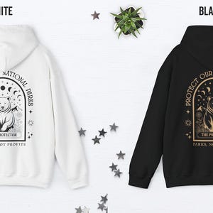 May include: White and black hoodies with a graphic design on the back. The design features a bear, crescent moons, and the text "PROTECT OUR NATIONAL PARKS" and "PARKS, NOT PROFITS".