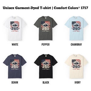 May include: A collection of unisex garment-dyed t-shirts in various colors, including white, pepper, chambray, denim, black, and ivory. Each shirt features a graphic with an American flag design and the number "250" with the years "1776-2026".