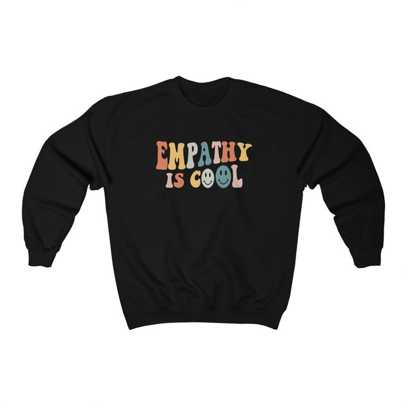 May include: Black sweatshirt with the text "EMPATHY IS COOL" in rainbow colors with smiley faces.