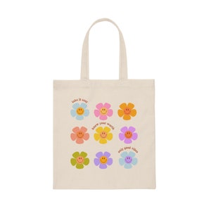 May include: A beige tote bag with a colorful floral design and the phrases "take it easy", "know your worth", and "only good vibes".