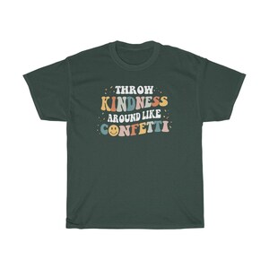 May include: A dark green t-shirt with the text "Throw Kindness Around Like Confetti" in colourful retro lettering. A smiley face is included in the text.