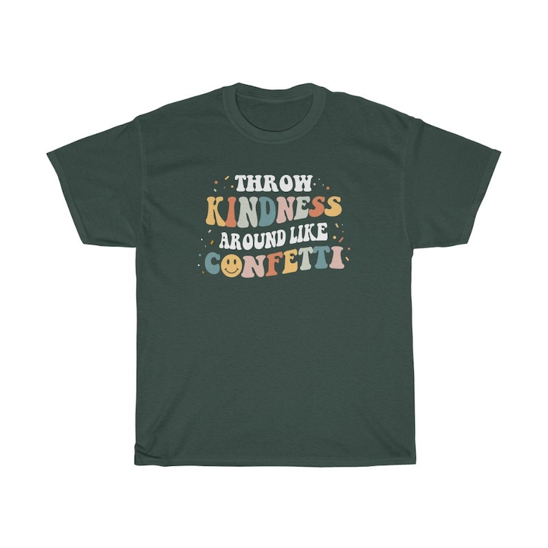 May include: A dark green t-shirt with the text "Throw Kindness Around Like Confetti" in colourful retro lettering. A smiley face is included in the text.