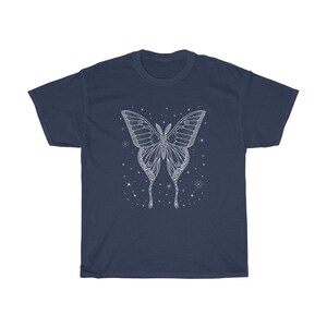 May include: A navy blue t-shirt with a white outline of a butterfly with intricate details. The butterfly is surrounded by small white stars.