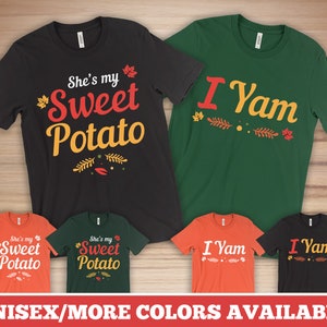 May include: A collection of unisex t-shirts in various colors, featuring the phrases "She's my Sweet Potato" and "I Yam" in a playful font. The designs include leaf accents, perfect for couples or friends.