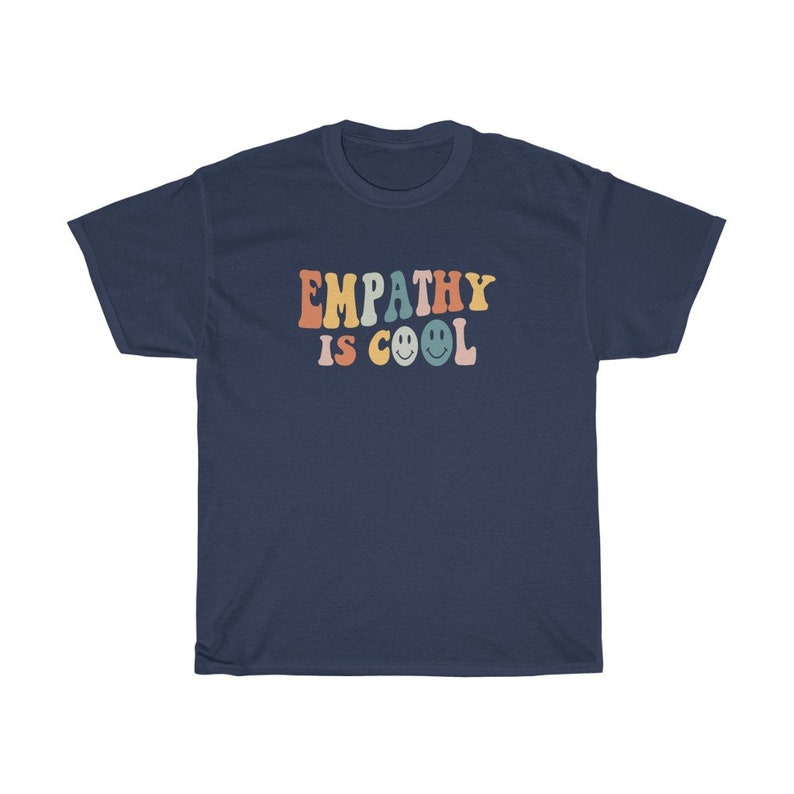 May include: Navy blue t-shirt with the text "EMPATHY IS COOL" in rainbow colours with smiley faces.