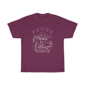 May include: A maroon t-shirt featuring a white outline of mushrooms and a crescent moon design.
