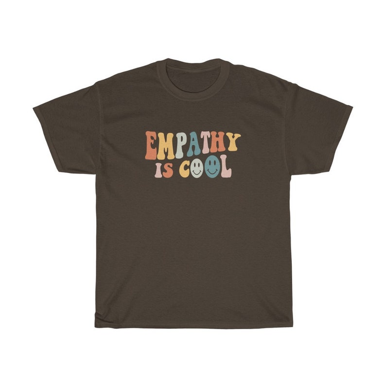 May include: A brown t-shirt with the text "EMPATHY IS COOL" in rainbow colours with smiley faces.
