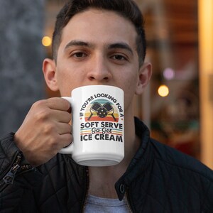 May include: White ceramic mug with a retro-style design featuring two pickleball paddles and the text "If you're looking for a soft serve, go get ice cream."