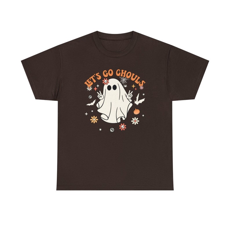 May include: A brown t-shirt with a white ghost graphic and the text "Let's Go Ghouls" in orange and white lettering. The ghost is wearing a flower crown and has peace signs for hands.