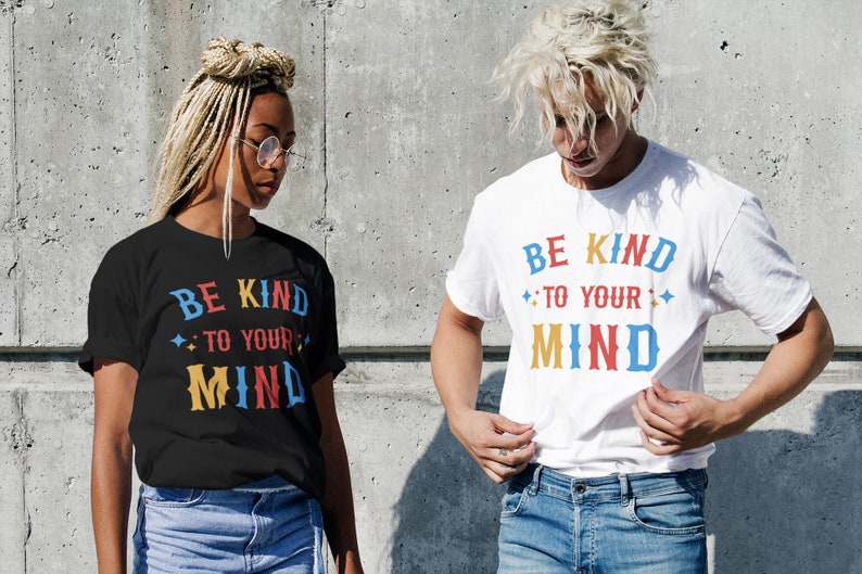 May include: Two people wearing black and white t-shirts with the text "Be Kind to Your Mind" in colorful letters. The text is surrounded by small stars.